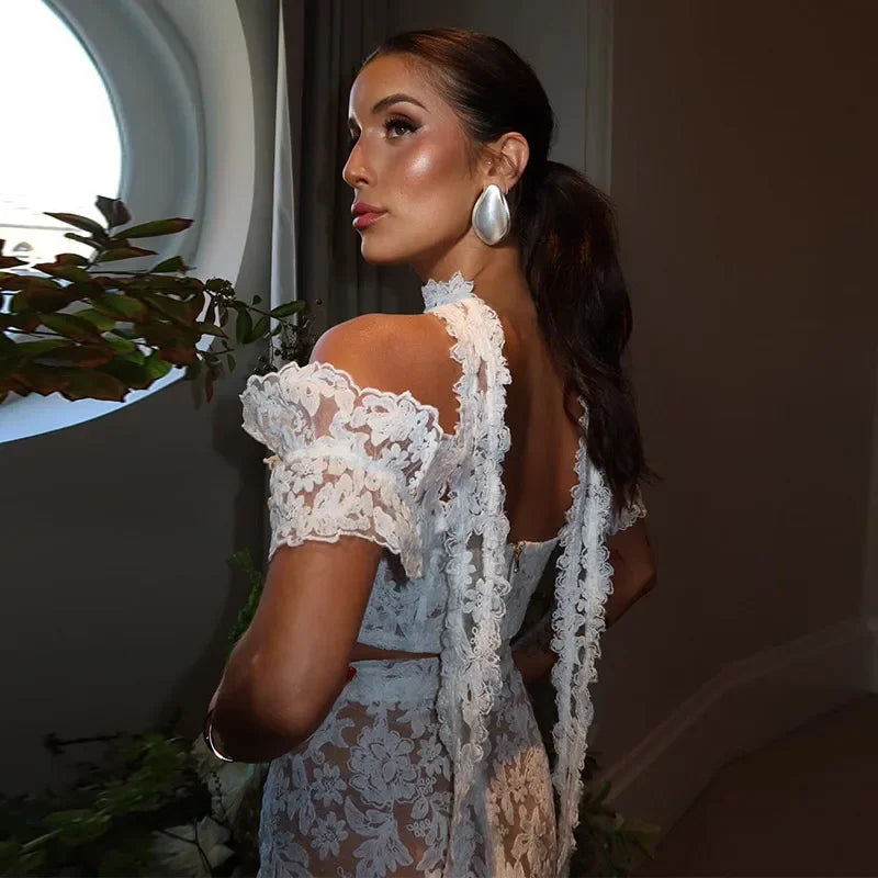 Woman wearing a white lace dress with a blurred background