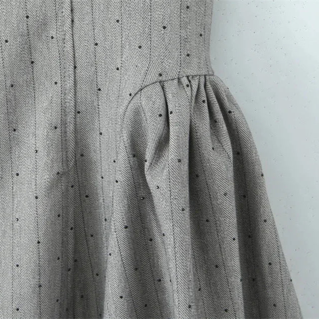Gray dress with black polka dots on a white background
