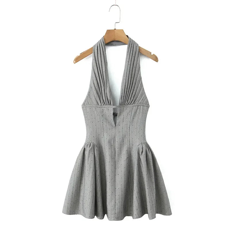 Gray halter dress on a wooden hanger against a white background