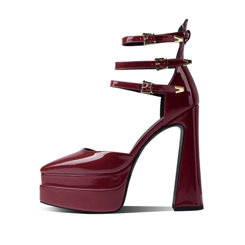 A glossy pointed toe platform block heel pump in burgundy color with adjustable ankle straps and a high heel.