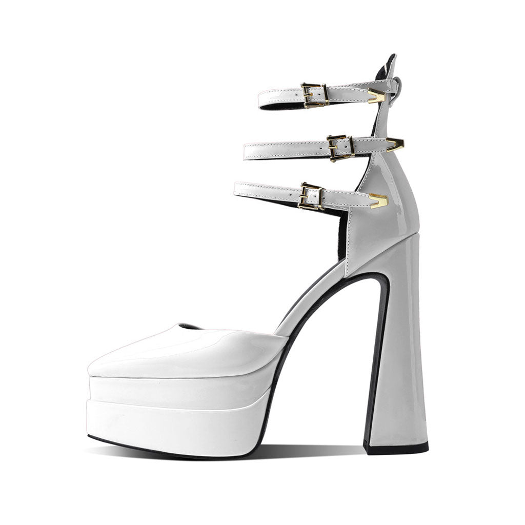 A glossy pointed toe platform block heel ankle strap pump in white color with high heels and adjustable straps.