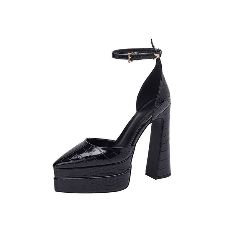 A black croc effect pointed toe platform chunky heel pump with an ankle strap and adjustable clasp.