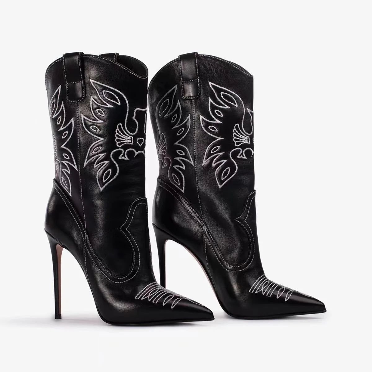 Black cowboy boots with white embroidery on a white background