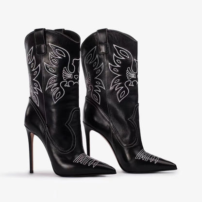 Black cowboy boots with white embroidery on a white background