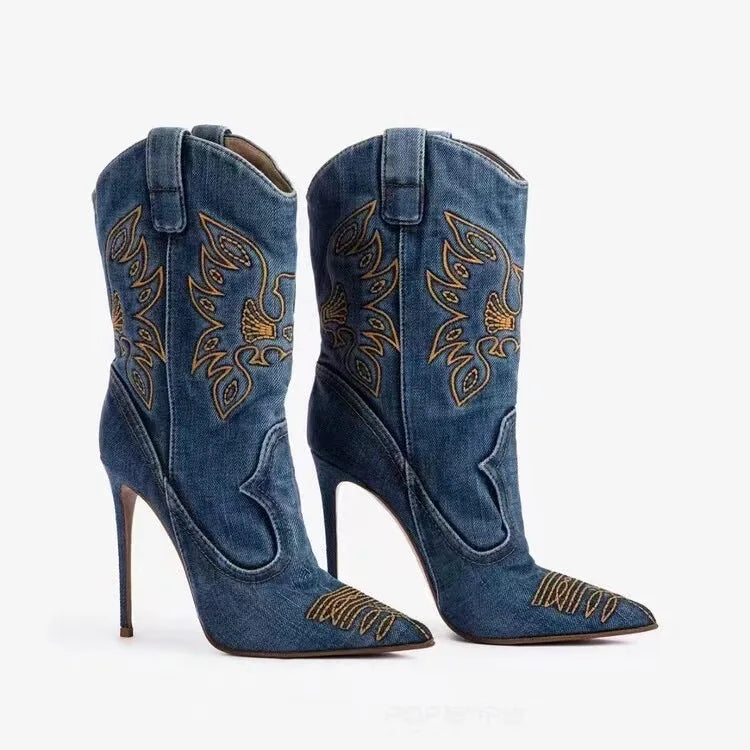 Blue denim cowboy boots with intricate gold embroidery on a white background