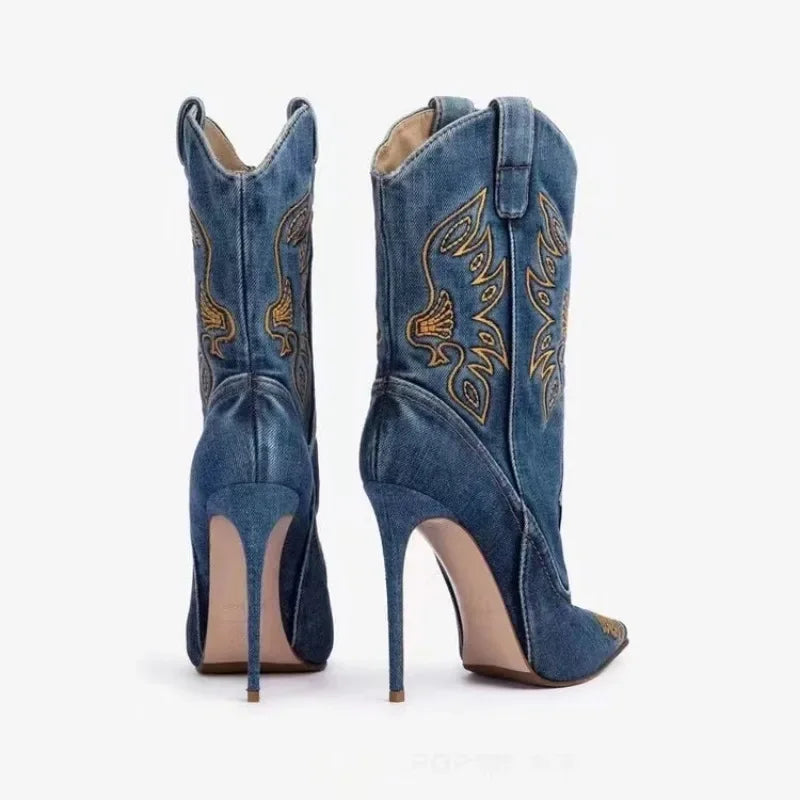 Blue denim high-heeled cowboy boots with gold embroidery on a white background