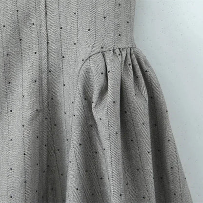 Gray dress with black polka dots on a white background