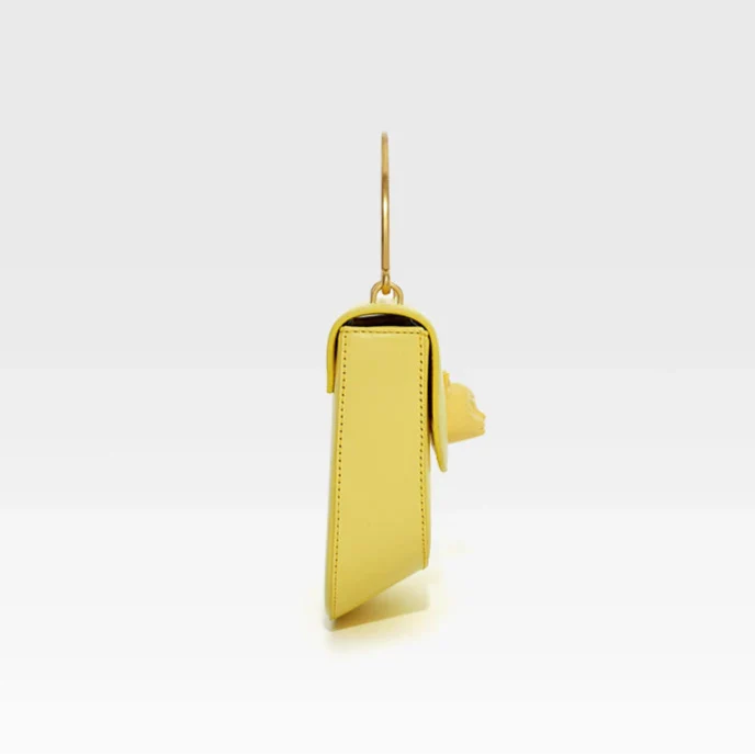 Yellow phone case with gold ring on a white background, featuring the brand 'Bafelli'.