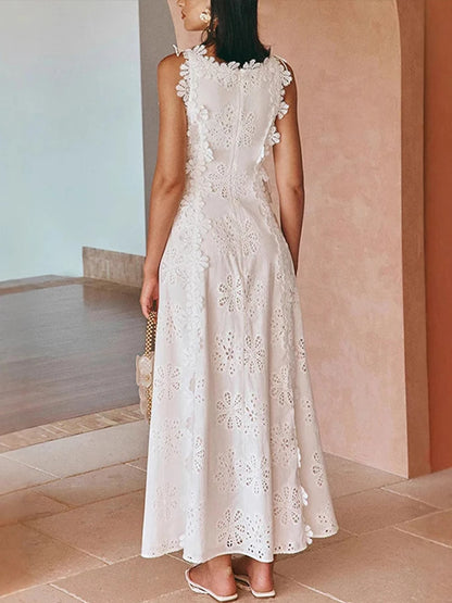 Back of white embroidered midi dress with fitted lace-up waist and flowing skirt