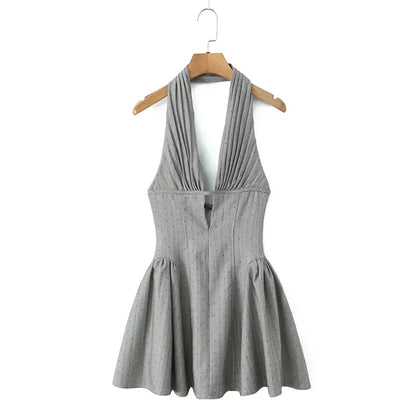 Gray halter dress on a wooden hanger against a white background