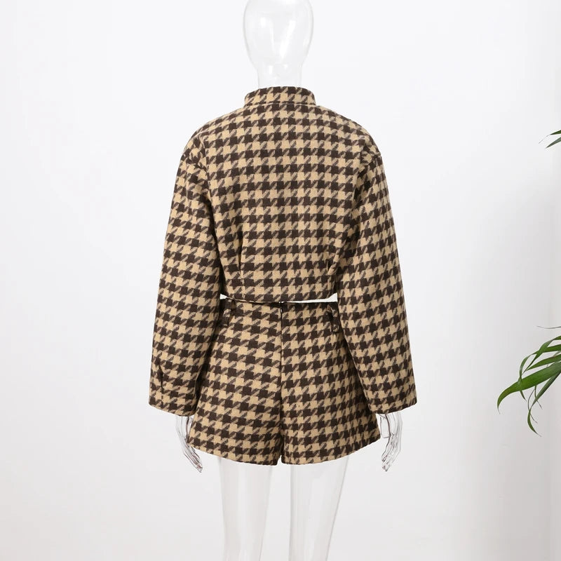 Houndstooth patterned jacket on a mannequin against a white background