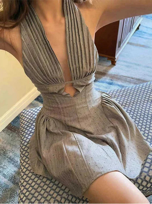 Gray halter neck mini dress with deep V-neck and backless design – front view on mannequin.