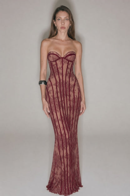 Red strapless lace corset maxi dress shown from the side with fitted bodycon shape and sheer lace eveningwear